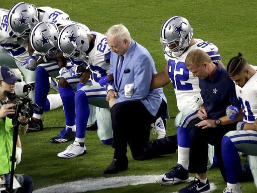 Jerry Jones with his players before the National Anthem Photo credit:AP